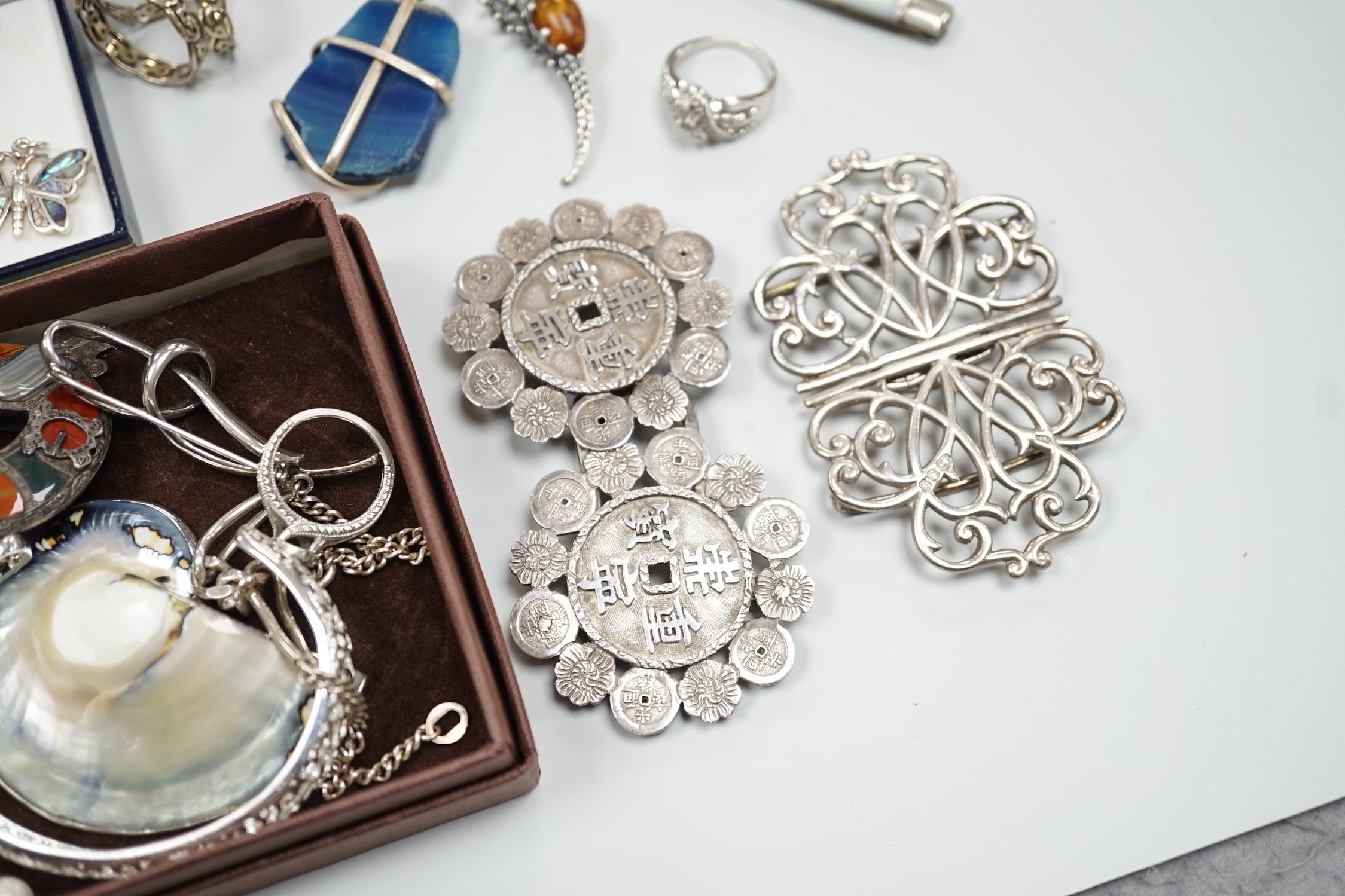 Mixed silver and white metal jewellery including a modern silver nurses buckle, an early 20th century white metal and Scottish hardstone brooch, Chinese white metal buckle by Wang Hing, etc.